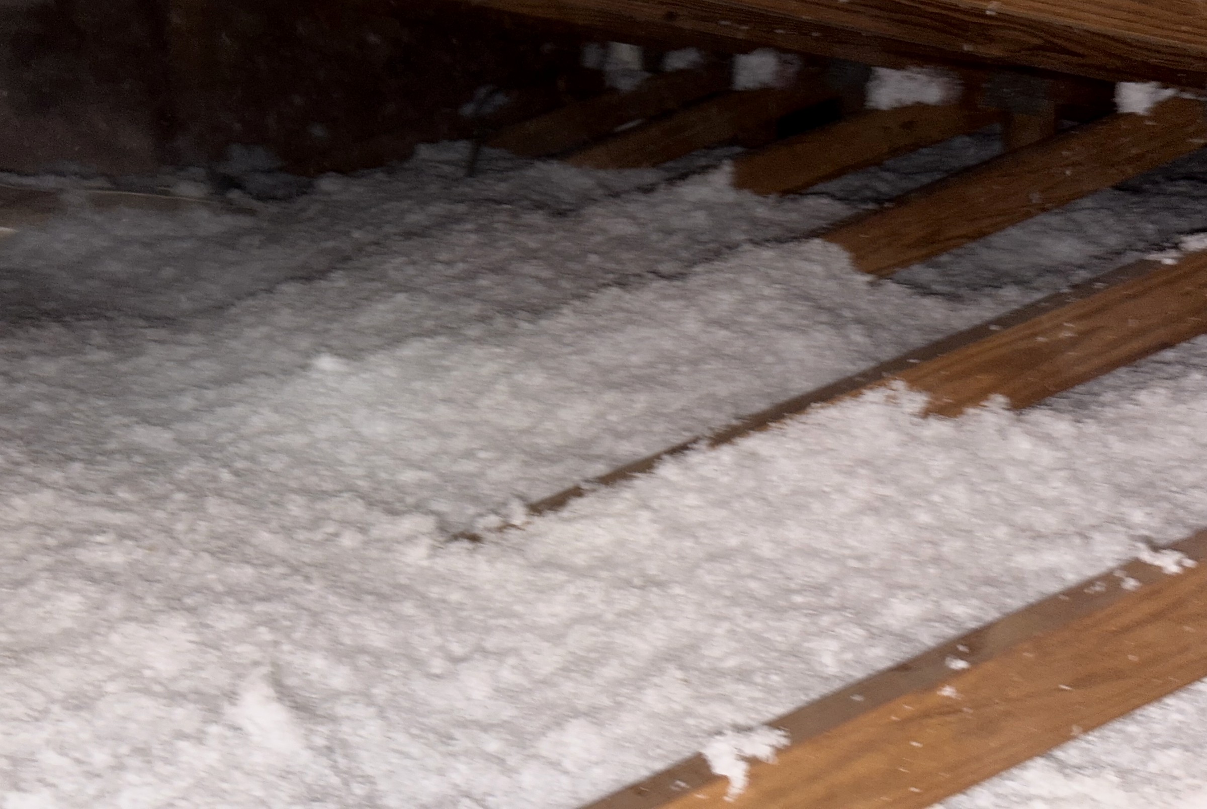Finished blown-in attic with joists still visible