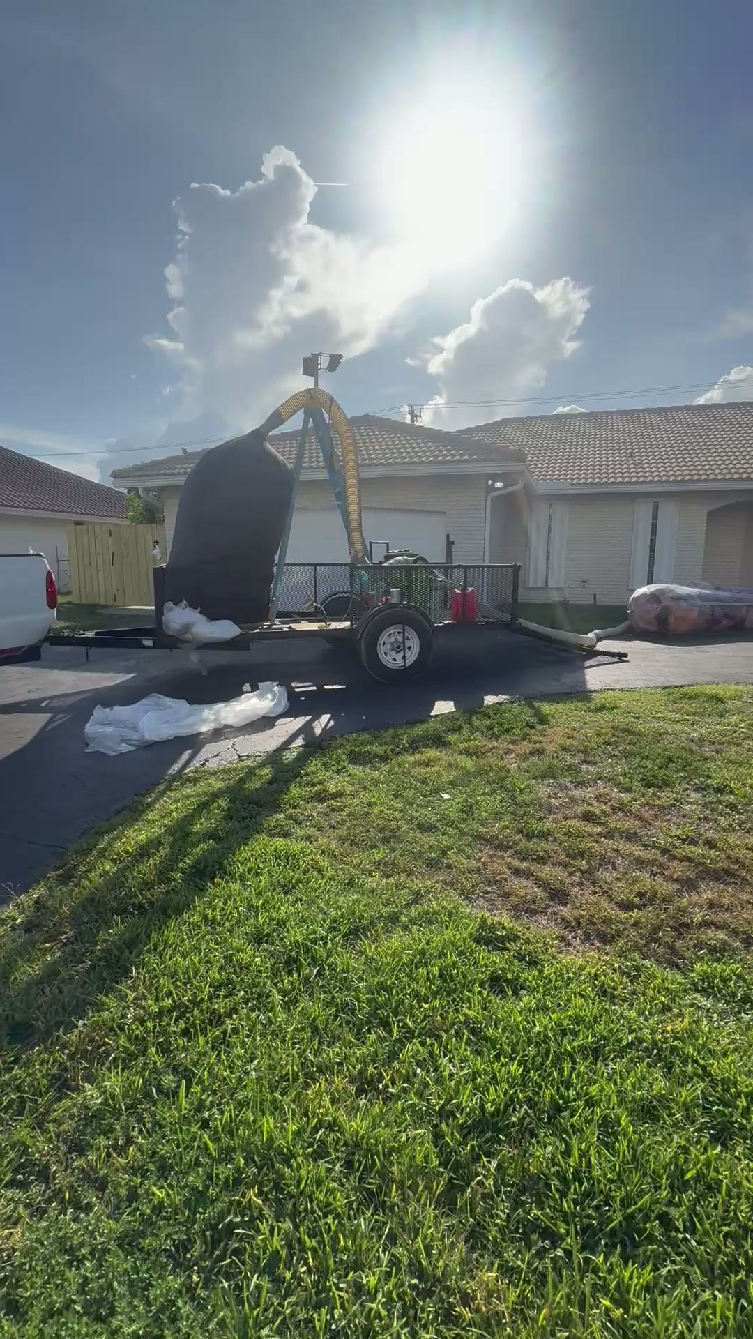 Blown-in insulation trailer parked on a South Florida driveway